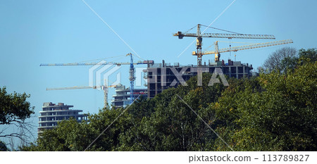 Kiev, Ukraine January 19, 2021: Tower construction cranes on the construction of high-rise buildings Kiev, Ukraine January 19, 2021: Tower construction cranes on the construction of high-rise buildings 113789827