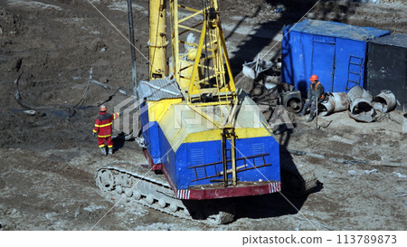 Kiev, Ukraine March 13, 2019:  Tractors and excavators work on the construction of the foundation zero cycle 113789873