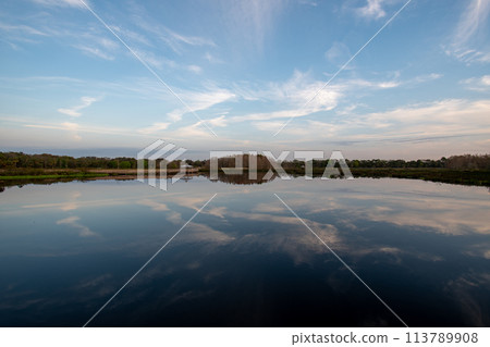 Boardwalk and sunrise cloudscape over wetlands of Green Cay Nature Center. 113789908