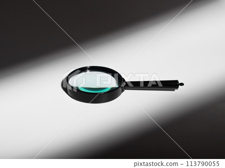 Abstract concept of light and shadow. Glass magnifier lens, transparent handle. Minimal optics 113790055
