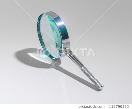 Silver magnifying glass. Explore, analyze, abstract concept. Detective clue, scrutiny tool for 113790353