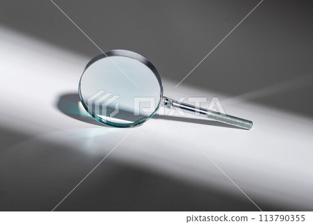 Silver magnifying glass. Zoom, search concept. Science object, minimal surveillance tool for reading Silver magnifying glass. Zoom, search concept. Science object, minimal surveillance tool for reading 113790355