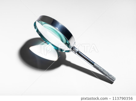 Silver metal magnifying glass. Optical concept for study, investigation, and exploration. Abstract Silver metal magnifying glass. Optical concept for study, investigation, and exploration. Abstract 113790356