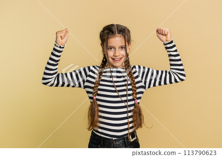 Fit sporty child girl kid showing biceps and looking healthy, feeling power strength success win Fit sporty child girl kid showing biceps and looking healthy, feeling power strength success win 113790623
