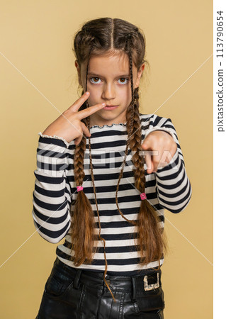 School child girl show pointing at her eyes and camera I am watching you gesture, spying on someone 113790654