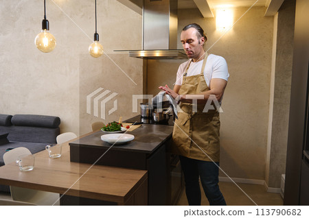Chef wiping hands with kitchen towel Chef wiping hands with kitchen towel 113790682