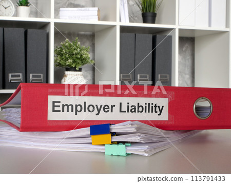 The folder Employer liability lies on a stack of papers. 113791433