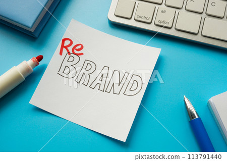 The word rebrand written with a marker on a white sticker. The word rebrand written with a marker on a white sticker. 113791440