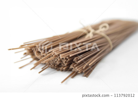 Buckwheat noodles closeup. Raw food ingredient. Dried buckwheat soba noodles. Traditional Japanese food Buckwheat noodles closeup. Raw food ingredient. Dried buckwheat soba noodles. Traditional Japanese food 113792012