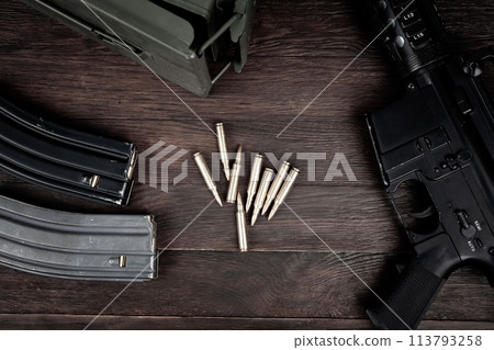 Rifle and Ammunition with magazine on wooden table Rifle and Ammunition with magazine on wooden table 113793258