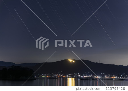 Manyo-bi fires and star trails lit up in the Setouchi night during Obon 113793428