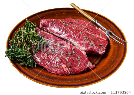 Raw rump cap steak or top sirloin steak in rustic plate with thyme and olive oil. Isolated on white background. Top view. 113793504