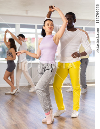 African American performing kizomba with woman in dance studio 113794966
