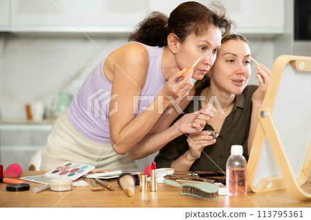 Woman doing eyebrow makeup with brush Woman doing eyebrow makeup with brush 113795361
