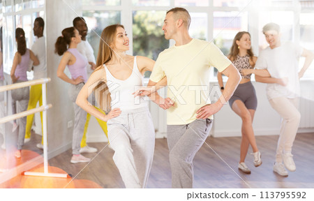 Group of middle aged dancers rehearsing ballroom dances in dance studio 113795592