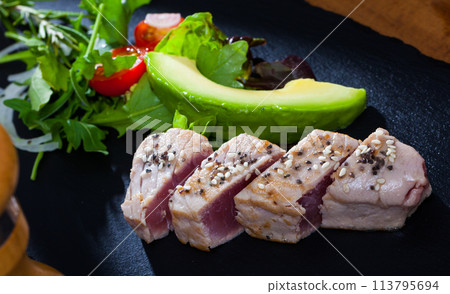 Light roasted tuna served with avocado Light roasted tuna served with avocado 113795694