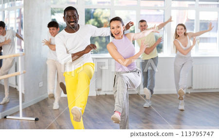 Group of different nationalities people learning swing steps at dance studio 113795747