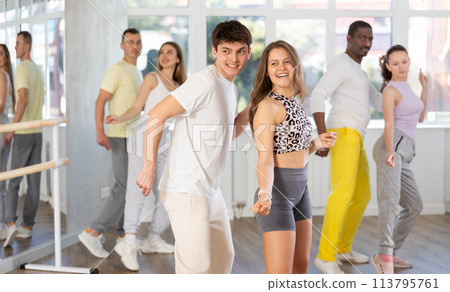 Group of different nationalities people learning swing steps at dance studio 113795761