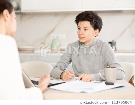 Boy studying with tutor 113795904