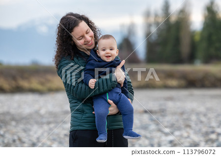 Mother and Baby Boy outside in nature by the river. 113796072