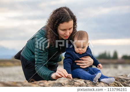 Mother and Baby Boy outside in nature by the river. 113796281