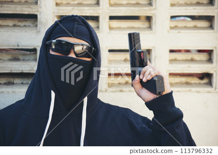 Terrorist war criminal men make a crime thief in black dress head shot. Bad anonymous soldier army with gun weapon in hand mafia attack. kidnap illegal bandit murderer. Criminal terrorist war concept Terrorist war criminal men make a crime thief in black dress head shot. Bad anonymous soldier army with gun weapon in hand mafia attack. kidnap illegal bandit murderer. Criminal terrorist war concept 113796332