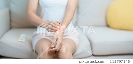 Arthritis and Muscle Pain Relief Cream concept. Woman having wrist pain at home, muscle ache due to De Quervain s tenosynovitis, ergonomic, Carpal Tunnel Syndrome or Office syndrome and Parkinson 113797146