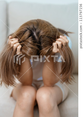 Stress, Sad and unhappy concepts. Alone asian Woman having headache, Young female feeling frustrated, exhausted and suffering 113797156