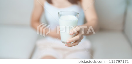 Lactose intolerance and Milk allergy concept. woman hold Milk glass and having abdominal cramps and pain when drink Cow Milk. Symptom stomach ache, Dairy intolerant, Nausea, Bloating, Gas and Diarrhea Lactose intolerance and Milk allergy concept. woman hold Milk glass and having abdominal cramps and pain when drink Cow Milk. Symptom stomach ache, Dairy intolerant, Nausea, Bloating, Gas and Diarrhea 113797171
