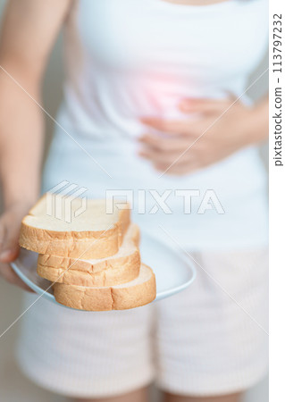Gluten intolerance, Gluten free and celiac disease or wheat allergy concept. woman hold Bread and having abdominal pain after eat gluten. stomach ache, Nausea, Bloating, Gas, Diarrhea and Skin rash Gluten intolerance, Gluten free and celiac disease or wheat allergy concept. woman hold Bread and having abdominal pain after eat gluten. stomach ache, Nausea, Bloating, Gas, Diarrhea and Skin rash 113797232