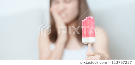 Teeth Sensitive to Cold concept. woman hold Ice cream and having toothache and pain after eat. Tooth Decay or Gum Disease, Grinding Teeth and Stress, Exposed Nerve Roots, Crack and Receding Gums Teeth Sensitive to Cold concept. woman hold Ice cream and having toothache and pain after eat. Tooth Decay or Gum Disease, Grinding Teeth and Stress, Exposed Nerve Roots, Crack and Receding Gums 113797237
