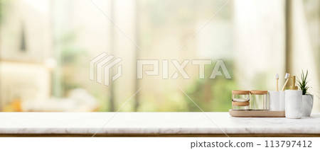Toiletries on a luxury white marble tabletop with a blurred background of a luxury bathroom. Toiletries on a luxury white marble tabletop with a blurred background of a luxury bathroom. 113797412