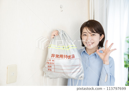 A woman with an emergency bag hanging on the wall 113797699