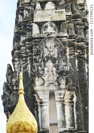 Buddhist art pattern stucco on the Main Prang of Wat Mahathat Worawihan. It is an architecture built in the 18th century. Located at Ratchaburi Province in Thailand. 113799131