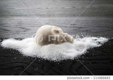 A skull-shaped sugar mound on a wooden surface symbolizing the concept of unhealthy diet A skull-shaped sugar mound on a wooden surface symbolizing the concept of unhealthy diet 113800883