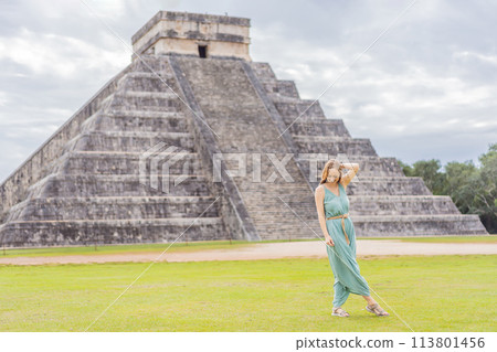 Beautiful tourist woman observing the old pyramid and temple of the castle of the Mayan architecture known as Chichen Itza these are the ruins of this ancient pre-columbian civilization and part of 113801456