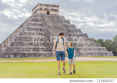 Father and son tourists observing the old pyramid and temple of the castle of the Mayan architecture known as Chichen Itza these are the ruins of this ancient pre-columbian civilization and part of Father and son tourists observing the old pyramid and temple of the castle of the Mayan architecture known as Chichen Itza these are the ruins of this ancient pre-columbian civilization and part of 113802017
