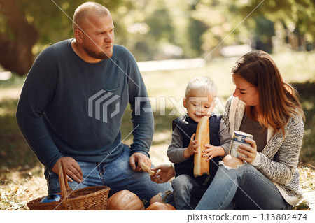 Family with little son in a autumn park Family with little son in a autumn park 113802474