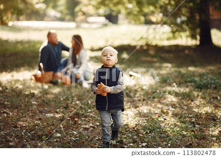 Family with little son in a autumn park Family with little son in a autumn park 113802478