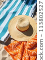 Sunbathing on a beach towel 113802527