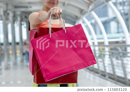 Shopaholic Women holding shopping bags ,money ,credit card person at shopping malls.Fashionable Woman love online website with sales tag on black Friday. E-commerce fashion digital marketing lifestyle 113803120