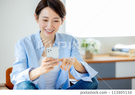 Female smartphone house relaxing Female smartphone house relaxing 113805138
