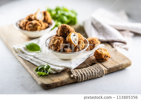 Fried mushrooms in breadcrumbs in a white bowl. Homemade crispy deep fried mushrooms 113805356