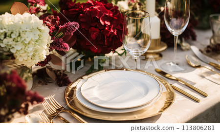 Wedding or formal dinner holiday celebration tablescape with hydrangea flowers in the English countryside garden, table setting and wine, floral table decor for family dinner party, home styling 113806281