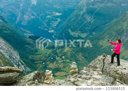 Tourist taking photo from Dalsnibba viewpoint Norway Tourist taking photo from Dalsnibba viewpoint Norway 113806515