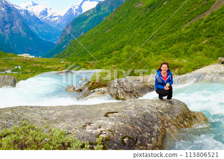 Tourist woman by Videfossen Waterfall in Norway Tourist woman by Videfossen Waterfall in Norway 113806521