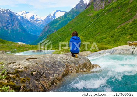 Tourist woman by Videfossen Waterfall in Norway 113806522