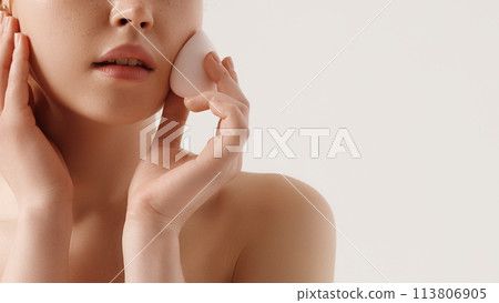 Girl cleaning face with cotton sponge. Beautiful Girl cleaning face with cotton sponge. Beautiful 113806905