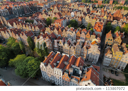 Beautiful panoramic architecture of old town in Gdansk, Poland at sunrise. Aerial view drone pov. Landscape cityscape City from Above. Small vintage historical buildings Europe Tourist Attractions Beautiful panoramic architecture of old town in Gdansk, Poland at sunrise. Aerial view drone pov. Landscape cityscape City from Above. Small vintage historical buildings Europe Tourist Attractions 113807072