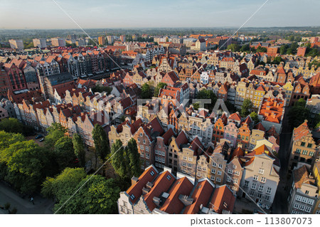 Beautiful panoramic architecture of old town in Gdansk, Poland at sunrise. Aerial view drone pov. Landscape cityscape City from Above. Small vintage historical buildings Europe Tourist Attractions Beautiful panoramic architecture of old town in Gdansk, Poland at sunrise. Aerial view drone pov. Landscape cityscape City from Above. Small vintage historical buildings Europe Tourist Attractions 113807073